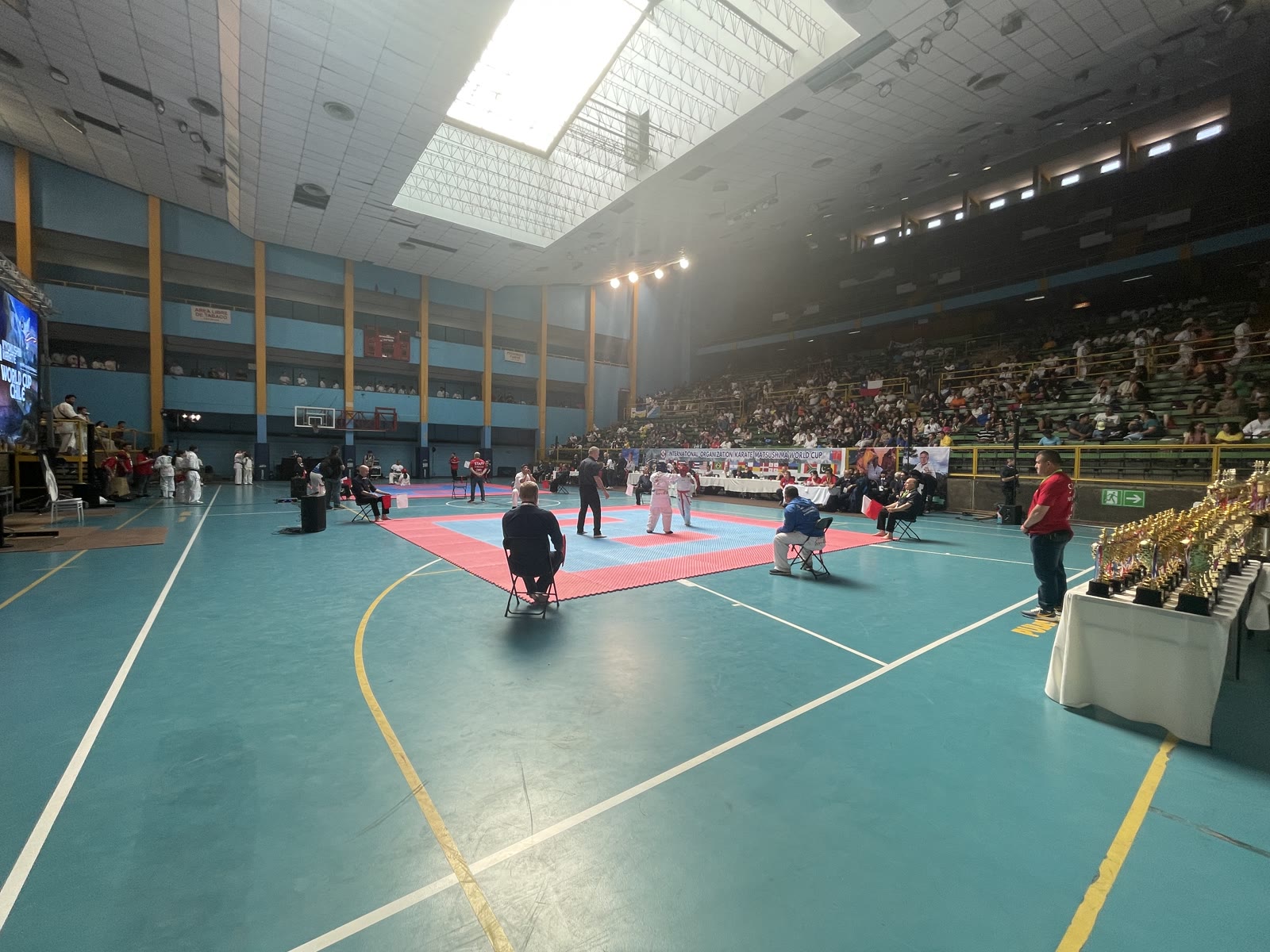 Vista general del arena del World Cup Chile 2023 con tatami y mesa de trofeos